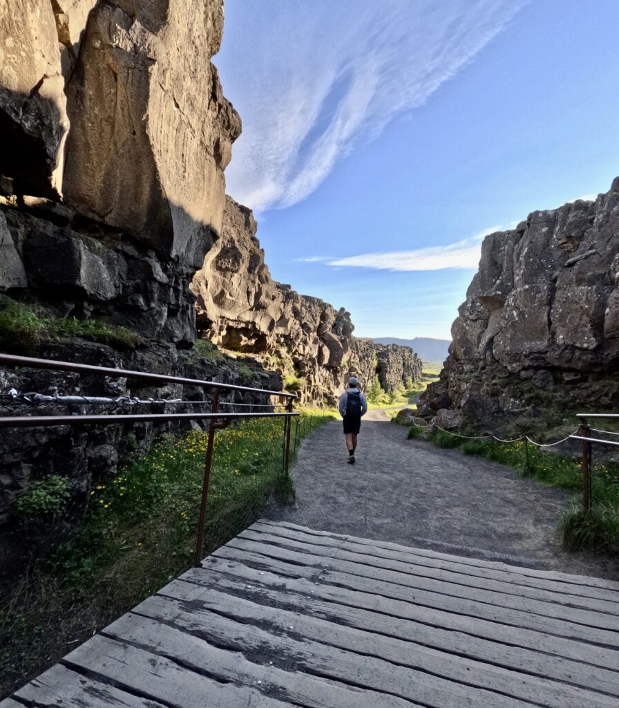 tourist walking on continental divide in thingvellir national park golden circle iceland