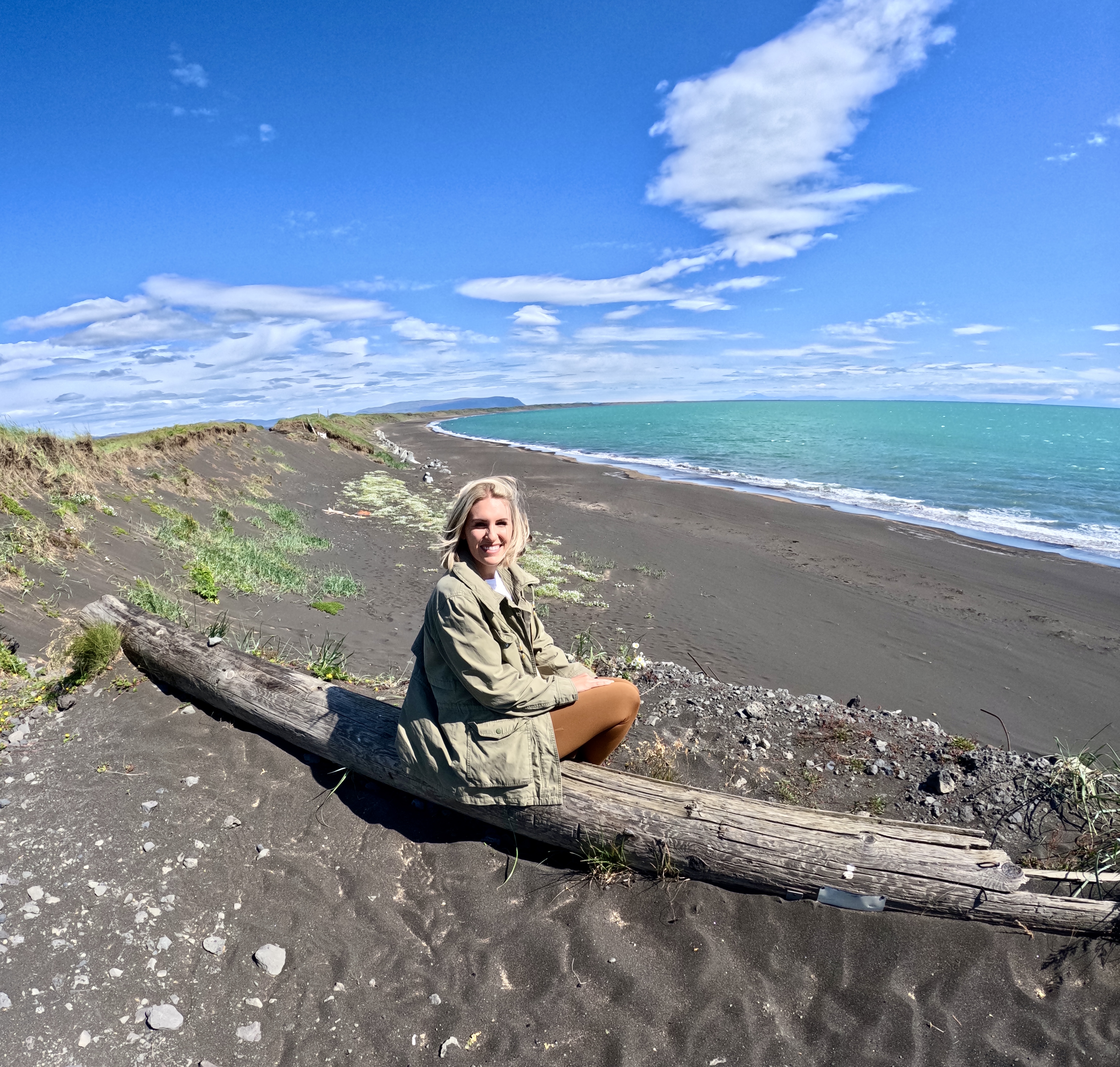 tourist couple visiting blank sand beach coastline of golden circle iceland