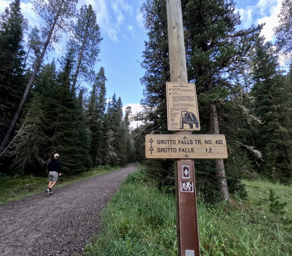 tourist couple hiking grotto falls trail in montana