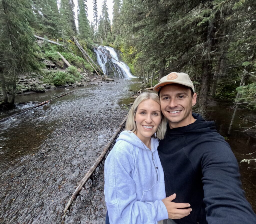 tourist couple hiking grotto falls trail in montana