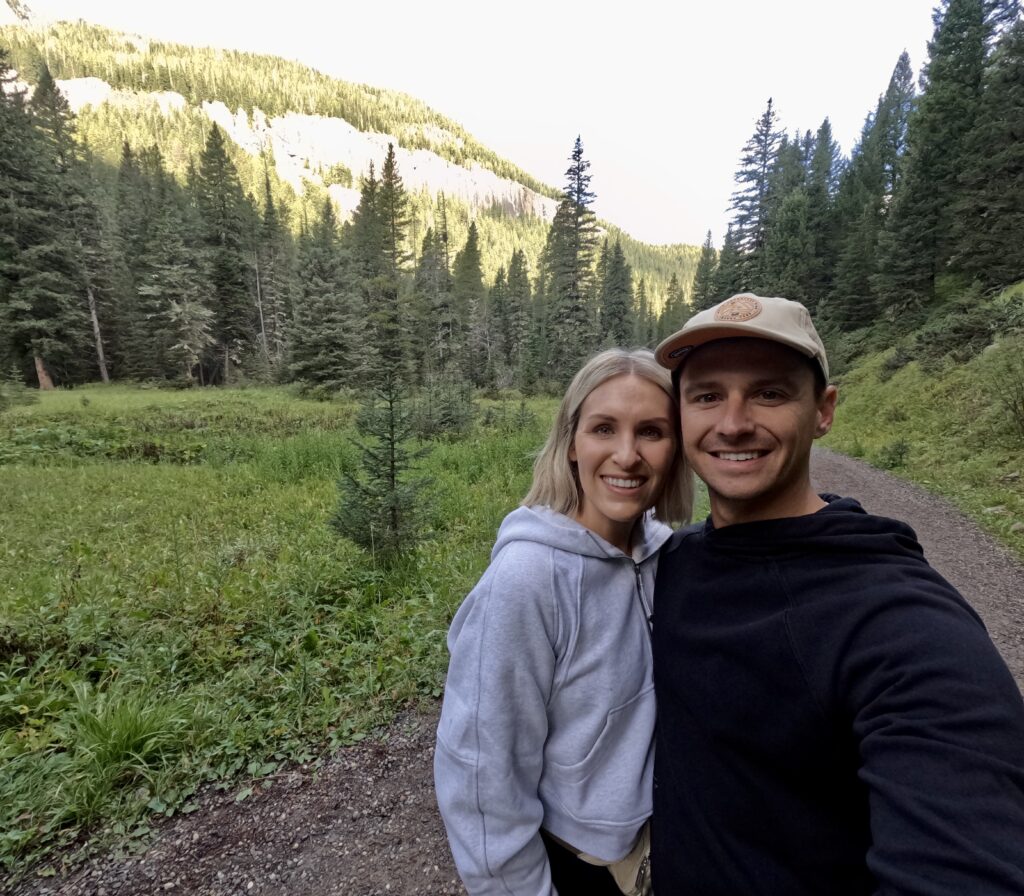 tourist couple hiking grotto falls trail in montana